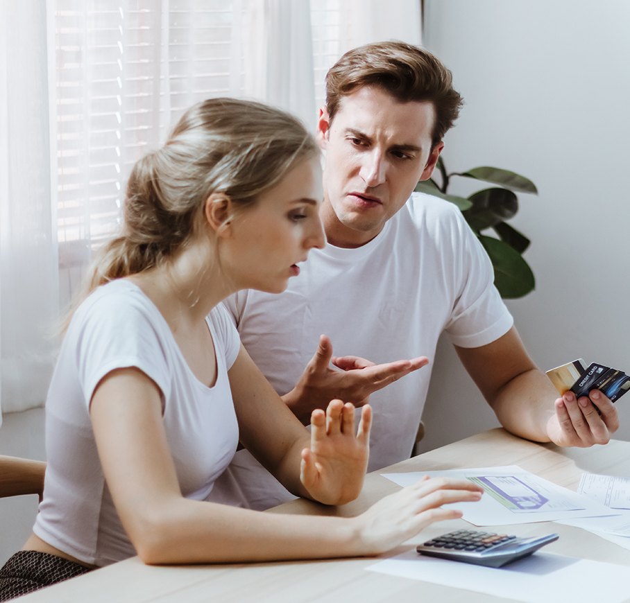 A couple at a table disagreeing over a credit card