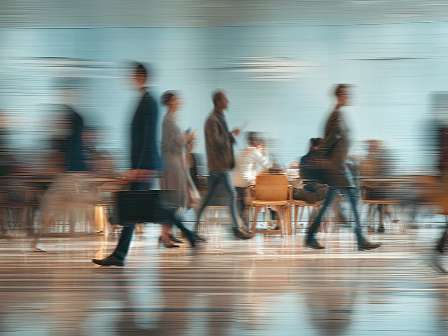 A blur of people hurrying through a busy concourse